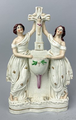 Lot 512 - STAFFORDSHIRE, SMALL CRUCIFIX ON A PILLAR-BEARING SMALL STOUP, WITH A WOMAN EITHER SIDE HOLDING THE BAR OF THE CROSS, CIRCA 1870'S