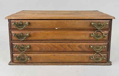 Lot 1038 - A TABLE TOP OAK CHEST OF FOUR DRAWERS