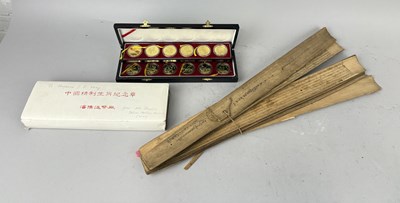 Lot 575 - A SET OF PAINTED PRAYER CARDS ON PAPYRUS ALONG WITH CHINESE GOLD-TONE ZODIAC COINS