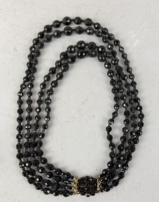 Lot 1219 - A BEADED THREE STRING NECKLACE