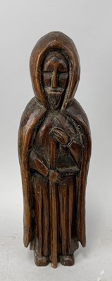 Lot 558 - A NORTH EUROPEAN CARVED WOODEN FIGURE WEARING A CLOAK