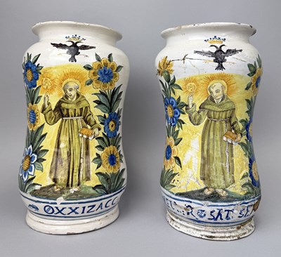Lot 175 - ALBARELLO, TWO EUROPEAN MAIOLICA PHARMACY JARS PAINTED WITH RELIGIOUS FIGURES AND DOUBLE EAGLES