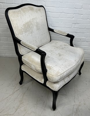 Lot 644 - A FRENCH FAUTEUIL WITH EBONISED FRAME, NEUTRAL VELVET UPHOLSTERED BACK AND SEAT