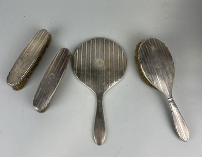 Lot 125 - A SILVER VANITY SET: TO INCLUDE MIRROR AND TWO BRUSHES