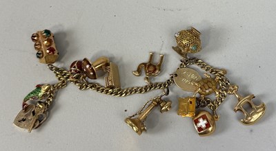 Lot 150 - AN 18CT GOLD CHARM BRACELET