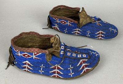 Lot 594 - A FINE AND RARE PAIR OF LAKOTA (SIOUX) NATIVE INDIAN BEADED HIDE MOCCASINS CIRCA 1870-1880