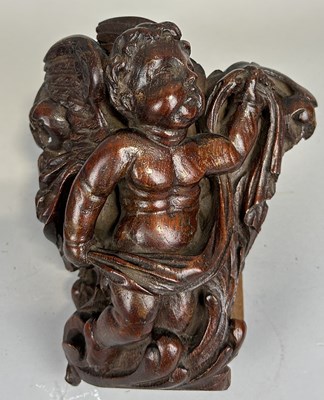 Lot 251 - A CARVED WOODEN ARCHITECTURAL FRAGMENT DEPICTING PUTTI