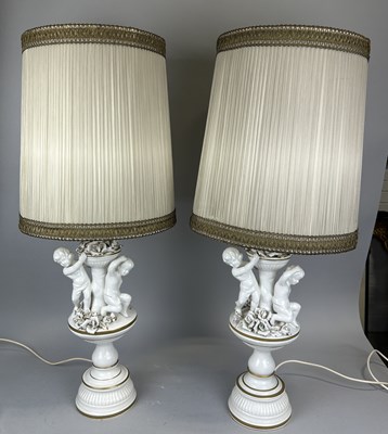 Lot 711 - A PAIR OF CERAMIC TABLE LAMPS WITH CUPIDS