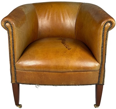 Lot 149 - A BROWN LEATHER TUB CHAIR, raised on legs...