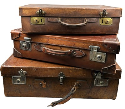 Lot 211 - THREE LEATHER SUITCASES, one possibly with...