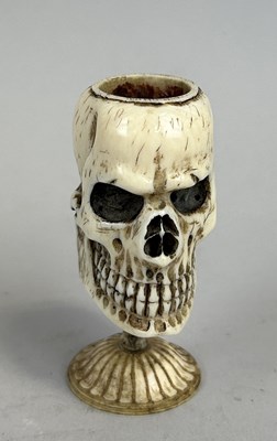 Lot 223 - MEMENTO-MORI: A 19TH CENTURY CARVED BONE SKULL MATCH STRIKER