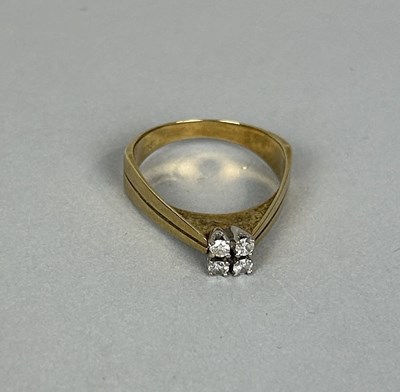 Lot 65 - A 14CT GOLD RING SET WITH FOUR SMALL DIAMONDS