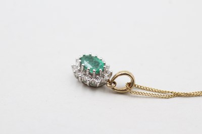 Lot 86 - A 9CT GOLD EMERALD AND DIAMOND HALO SET PENDANT ON CHAIN (1.7g)