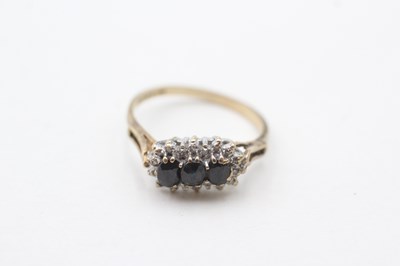 Lot 98 - A 9CT GOLD SAPPHIRE THREE STONE RING WITH DIAMOND FRAME (2g)