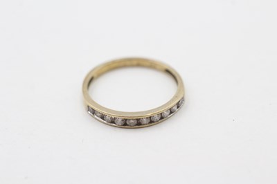 Lot 109 - A 9CT GOLD CHANNEL SET DIAMOND RING (1.1g)