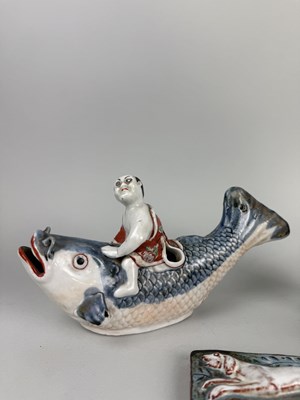 Lot 319 - A JAPANESE ARITA STYLE BOY RIDING A CARP ALONG WITH A BLUE GLAZED CERAMIC BOWL, CHINESE BRUSH POT AND GLAZED DOG RELIEF