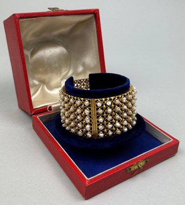 Lot 22 - A HIGH CARAT GOLD AND SEED PEARL BANGLE, 

The...