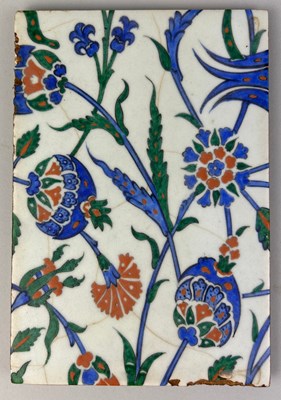 Lot 134 - A LARGE IZNIK TILE, painted with flowers in...