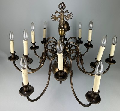 Lot 349 - A LARGE BRASS TWELVE ARM CHANDELIER WITH EAGLE...