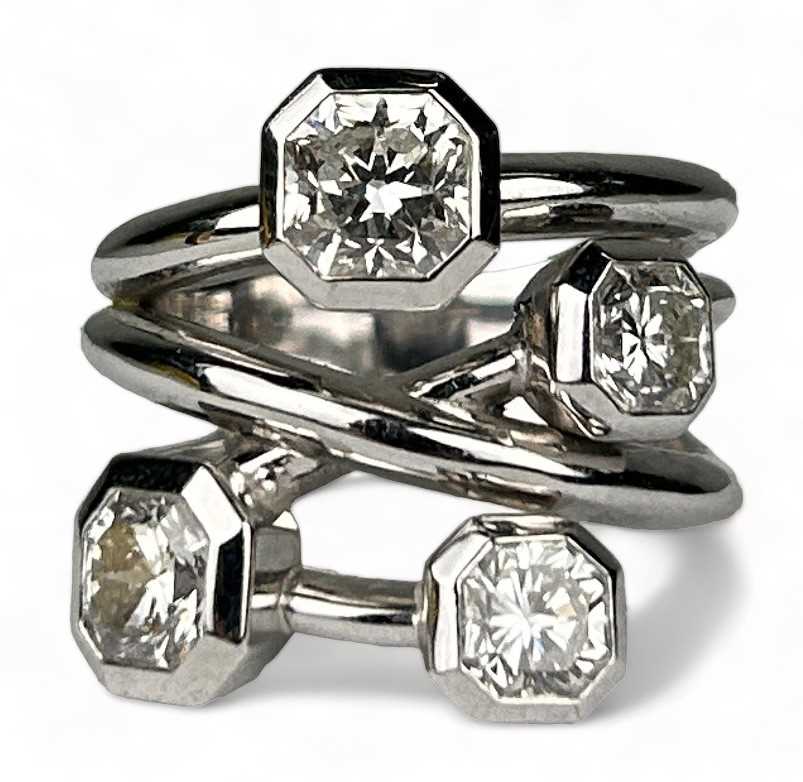 Lot 1 - A PLATINUM RING SET WITH FOUR CORNER SQUARE...