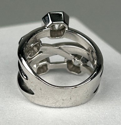 Lot 1 - A PLATINUM RING SET WITH FOUR CORNER SQUARE...