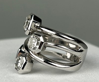 Lot 1 - A PLATINUM RING SET WITH FOUR CORNER SQUARE...