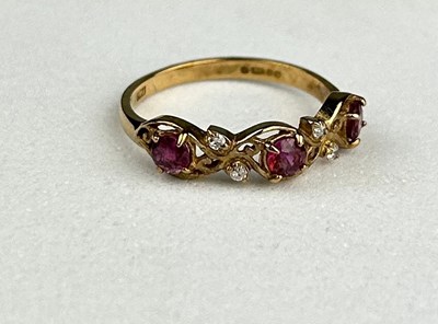 Lot 28 - A 9CT GOLD RING INSET WITH THREE SMALL RUBIES...