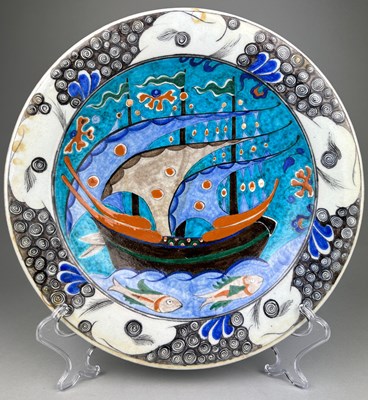 Lot 134 - AN UNUSUAL IZNIK GLAZED PLATE PAINTED WITH...