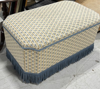 Lot 702 - AN UPHOLSTERED OTTOMAN TRUNK WITH FRINGE