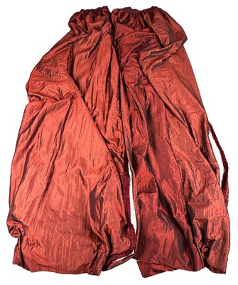 Lot 380 - A PAIR OF RED SILK CURTAINS, with velvet...