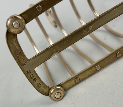 Lot 12 - A PAIR OF SILVER TOAST RACKS MARKED FOR HARRODS ALONG WITH A SUGAR SHAKER