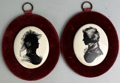 Lot 414A - A PAIR OF CERAMIC SILHOUETTES ON RED VELVET (2)