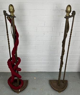 Lot 525 - TWO METAL ROPE STANCHIONS, with brass pine...