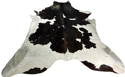 Lot 555 - A COWHIDE RUG ALONG WITH A SMALL COWHIDE...