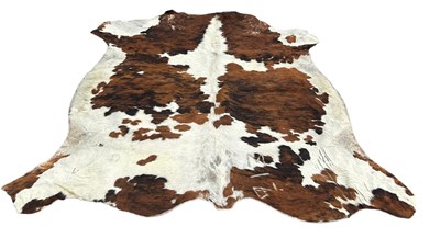 Lot 557A - A LARGE COW HIDE RUG,

210cm x 200cm