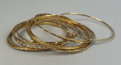 Lot 9 - A COLLECTION OF THIRTEEN CHINESE GOLD BANGLES MARKED 22CT OR 90% (13)