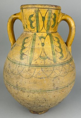 Lot 21 - A NORTH AFRICAN GLAZED TERRACOTTA JUG, 

40cm...