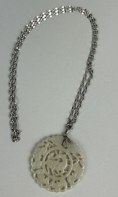 Lot 186 - A CHINESE JADE RETICULATED DISC POSSIBLY LATE 19TH CENTURY WITH SILVER CHIAN