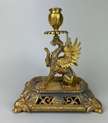 Lot 29 - A GILT METAL CANDLESTICK IN THE FORM OF A...