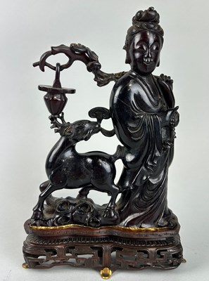 Lot 59 - A CHINESE AMBER STATUE DEPICTING HSI WANG MU,...