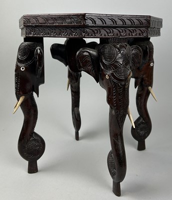 Lot 1126 - AN INDIAN OCCASIONAL TABLE WITH ELEPHANT HEAD SUPPORTS