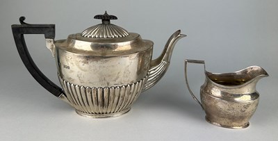 Lot 11 - A VICTORIAN SILVER TEA POT AND MILK...